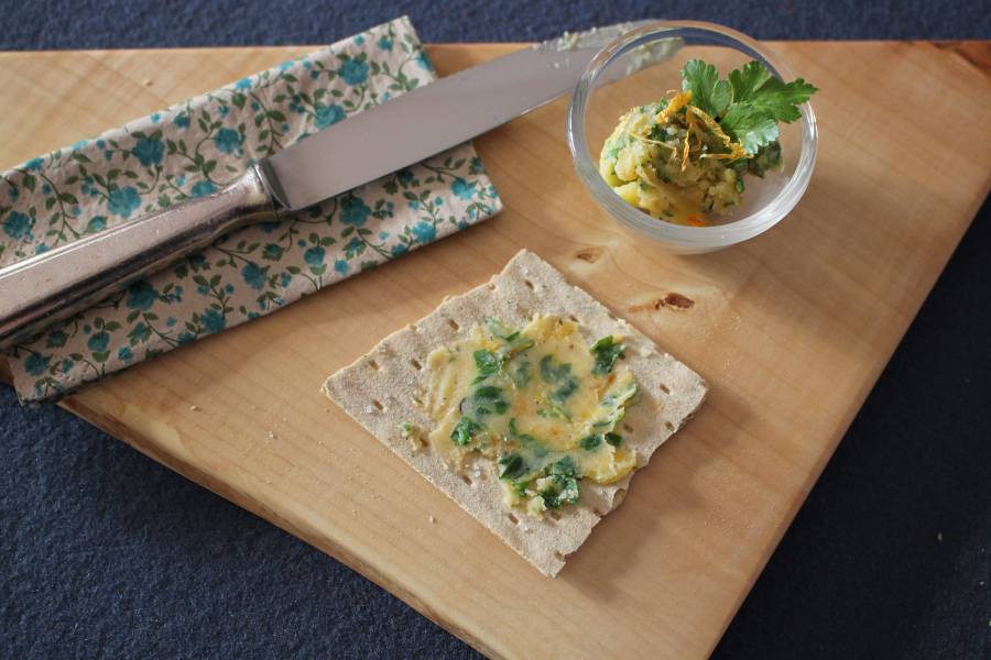 Ein Schüsselchen mit Ringelblumenblutter und ein Stück Knäckebrot mit Butter