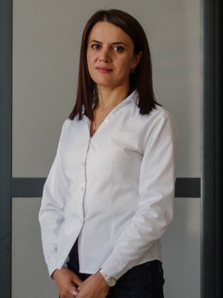 Projektkoordinatorin Hayarpi Aghakhanyan von der Community Development NGO. Sie trägt lange, dunkle Haare, ein weiße Bluse und eine schwarze Hose.